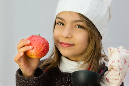 a girl holding an apple