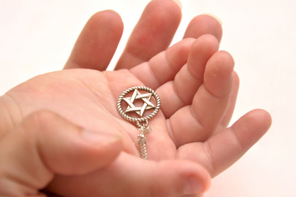 a hand holding a star of david
