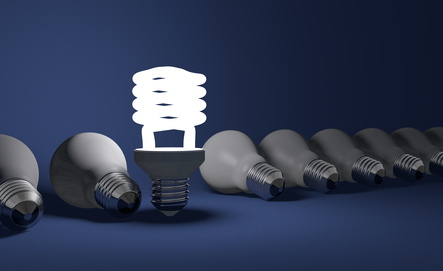 a row of lightbulbs, one is lit
