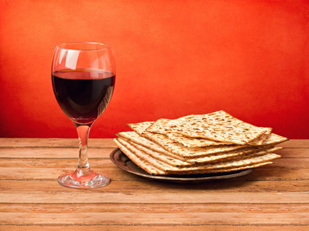 a glass of wine and matzohs