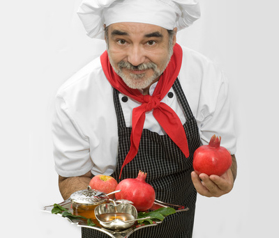 a cook holding pomgrenates