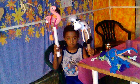 a boy holding puppets