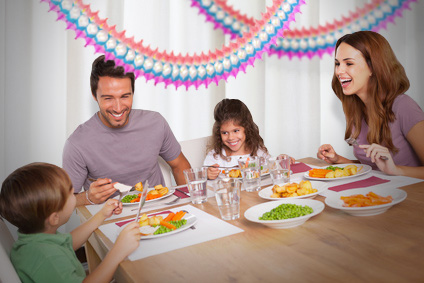 a family sitting in a sukkah